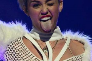 Ethan Miller / Getty Images Entertainer Miley Cyrus winks and sticks out her tongue as she performs during the iHeartRadio Music Festival at the MGM Grand Garden Arena on September 21, 2013 in Las Vegas, Nevada.