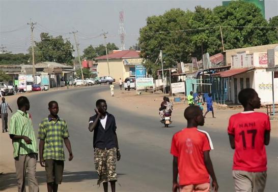 South Sudanese people walk along a street in capital Juba